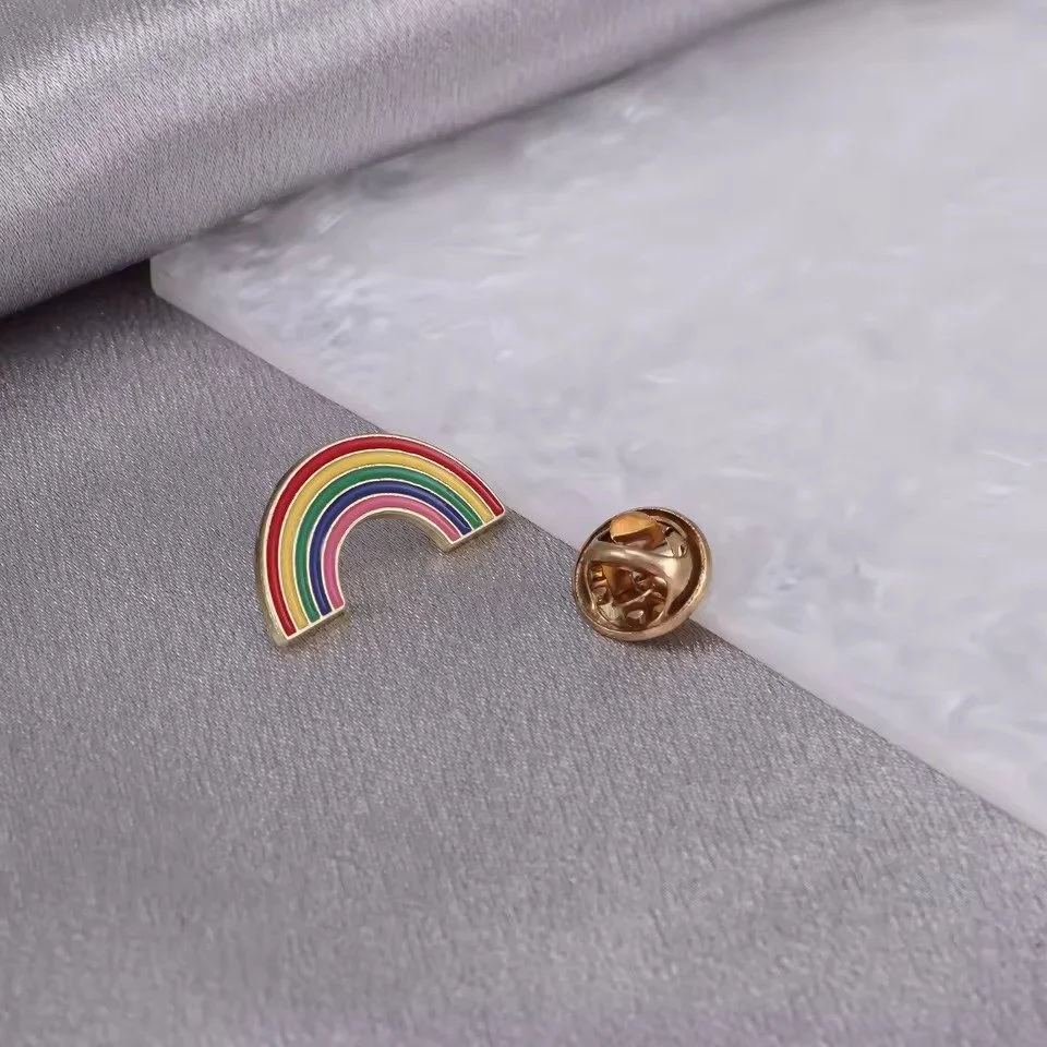 Rainbow pride flag enamel pin with a black metal outline and vibrant stripes.