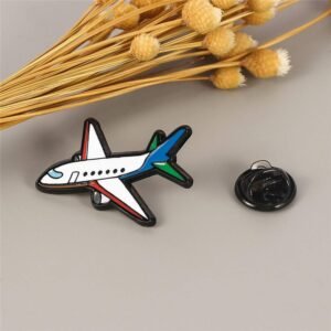 Airplane enamel pin featuring a white fuselage with red and blue accents and a black rubber clutch.