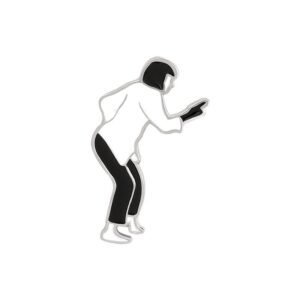 A black and white enamel pin showing a stylized silhouette of Mia Wallace dancing, outlined in silver.