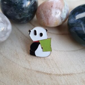 Kawaii panda enamel pin featuring a cute bear reading a green book.