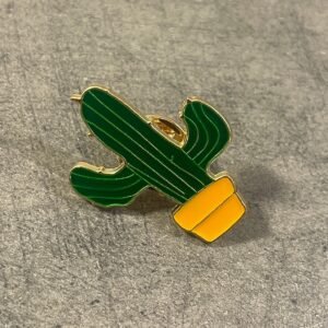 Cute green saguaro cactus in a yellow pot enamel pin with gold accents.