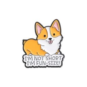 An enamel pin of a smiling Corgi sitting above a white banner that reads I'm Not Short I'm Fun-Size in black capital letters.