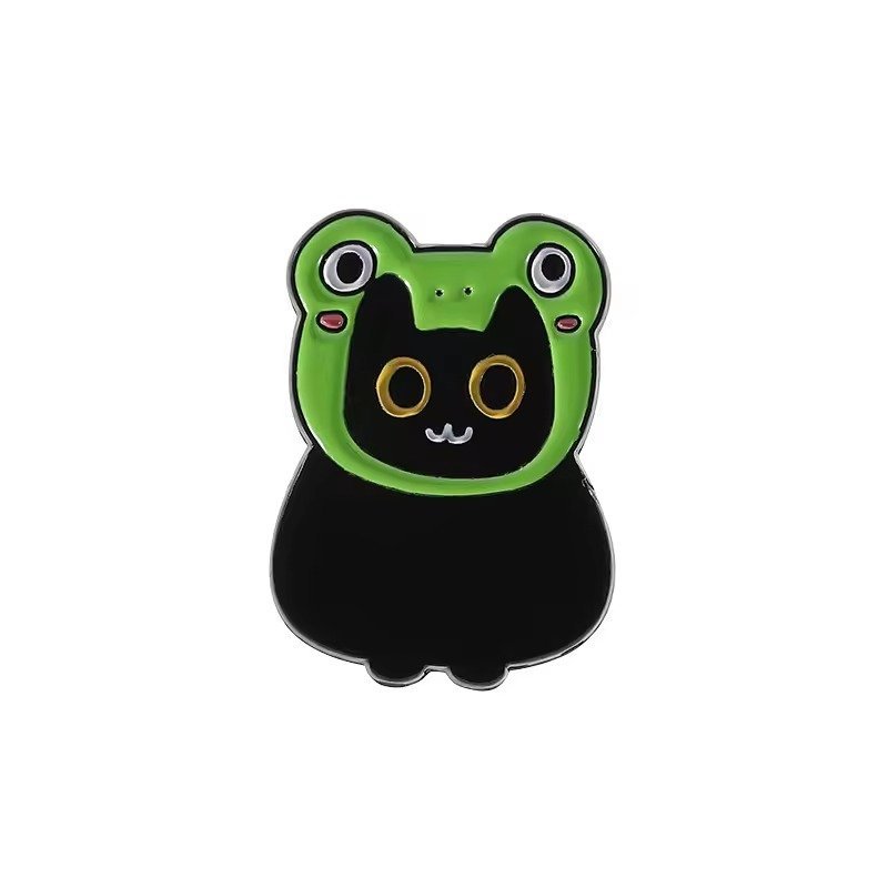 A cute black cat enamel pin wearing a bright green frog-shaped hoodie with pink cheek details.