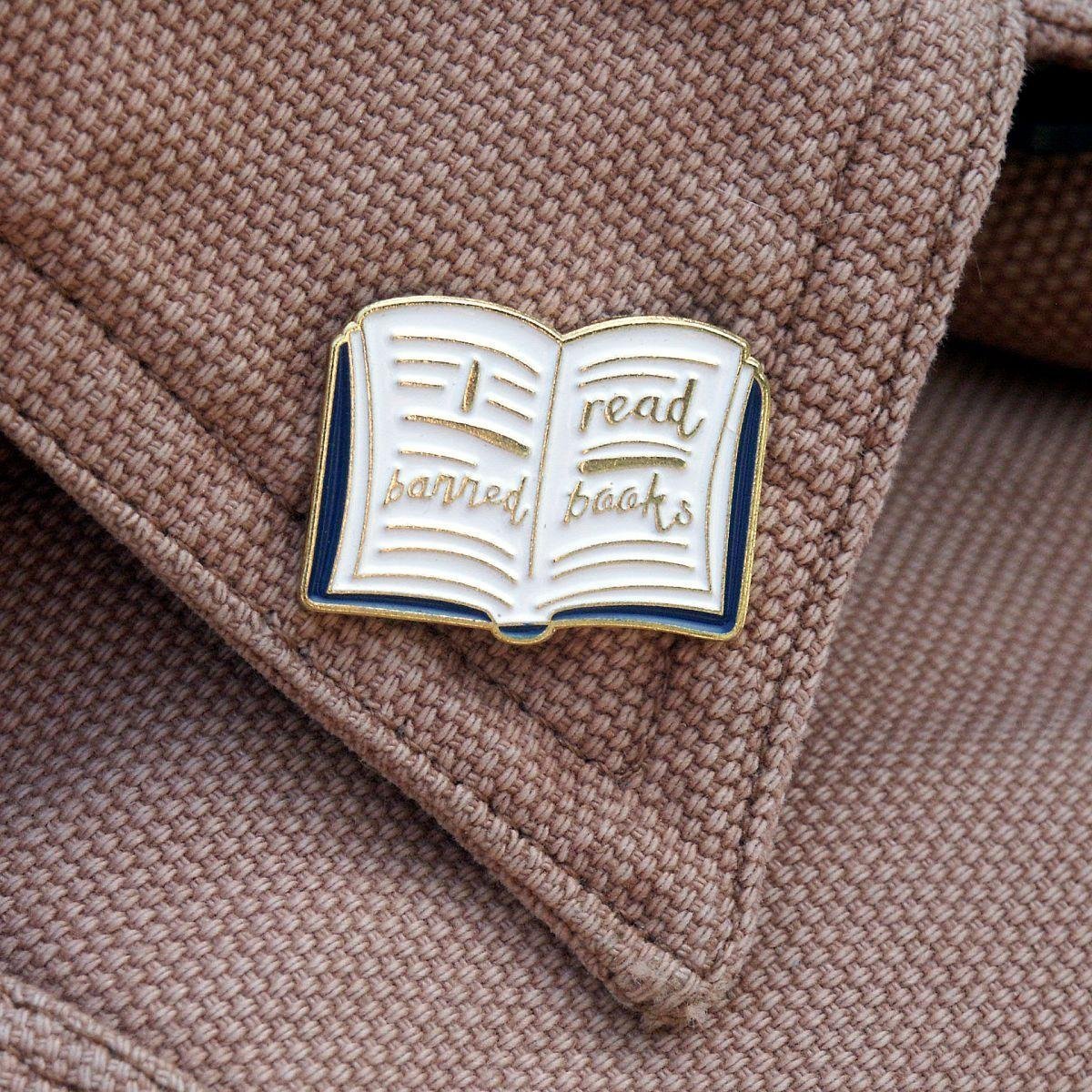 Literary girl aesthetic pin styled on a vintage jacket collar for a classic reader look.
