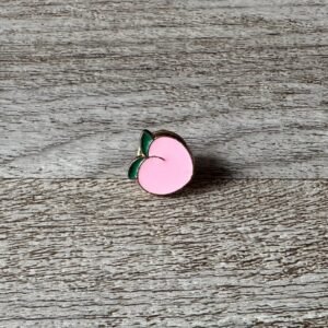 Peach enamel pin showing a cute fruit design with gold metal plating.