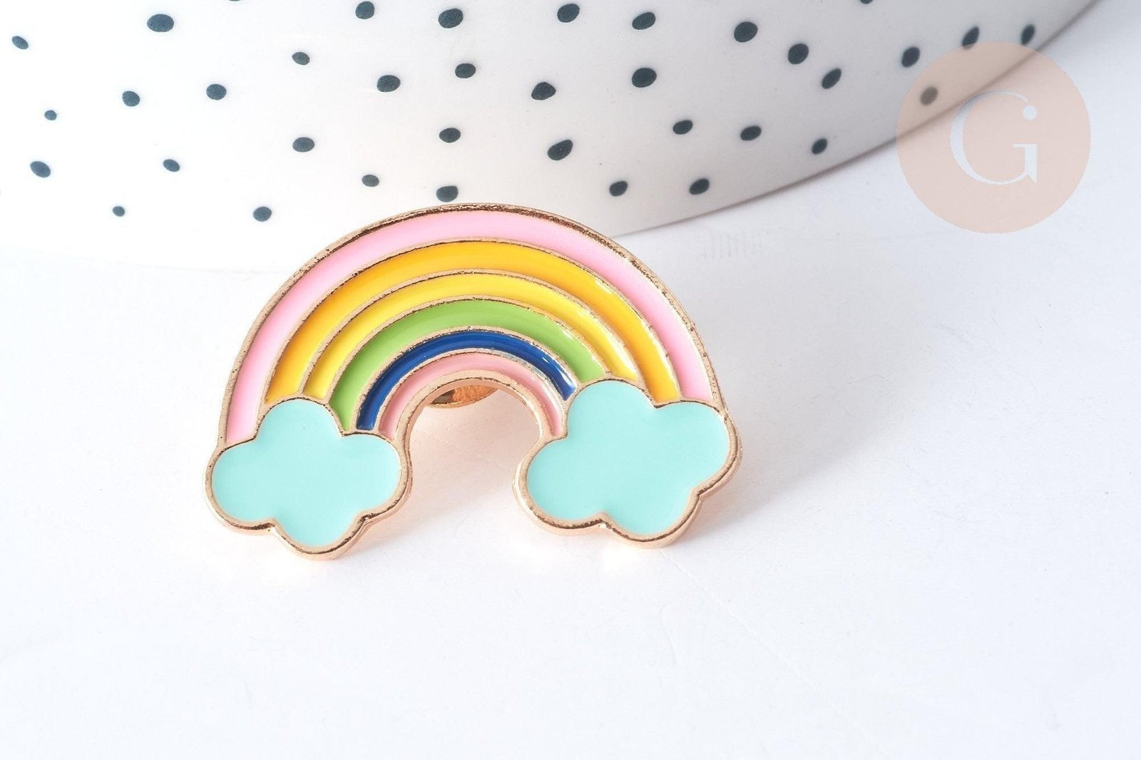 Rainbow enamel pin with soft pastel colors and fluffy blue clouds.