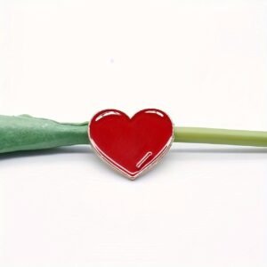 Red heart pin with a gold metal border and bright red enamel finish.