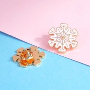 Snowflake enamel pin featuring a delicate silver geometric design on a dark blue enamel base.