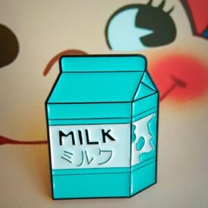 Milk carton enamel pin in turquoise with Japanese katakana text.
