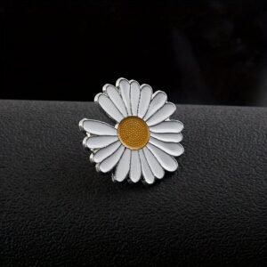 White daisy flower pin with vibrant yellow center and silver metal detailing.