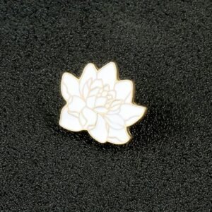 A high-quality white lotus flower pin featuring detailed gold metal petal outlines.