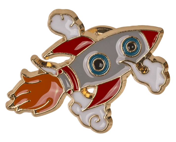 Cute rocket pin – fun rocket with big blue eyes red fins orange flames and white clouds hard enamel badge gold base