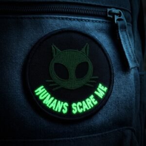 Alien cat patch glowing in the dark on a backpack