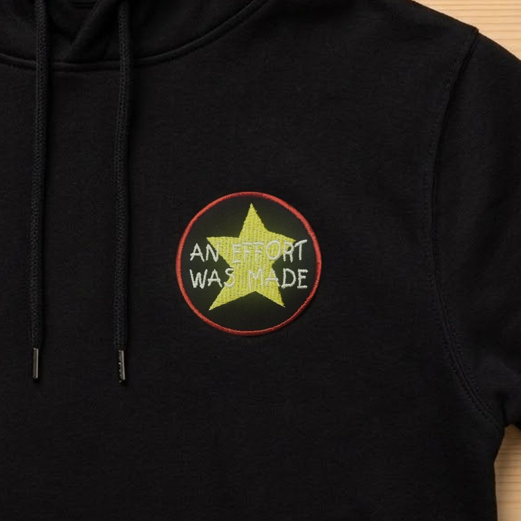An Effort Was Made patch on a black hoodie