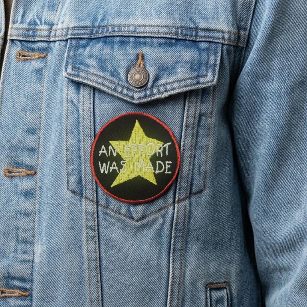 An Effort Was Made patch on a light denim jacket pocket