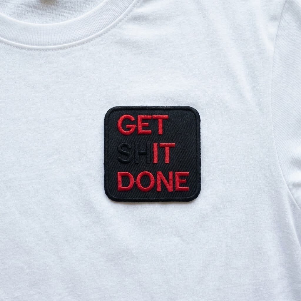 Get It Done patch with red text on the chest of a white t-shirt