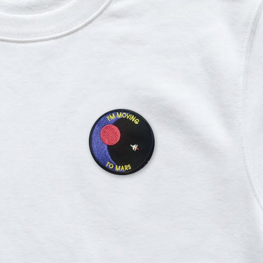 I'm Moving To Mars patch on a white sweatshirt