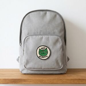 Not normal cat patch on a grey backpack